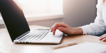 business-woman-working-on-laptop-in-her-office-2210x1473-1
