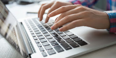 cropped-view-hands-typing-laptop_1262-3196