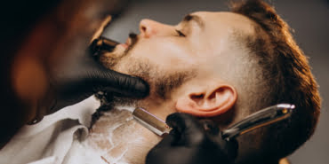 handsome-man-cutting-beard-barber-salon_1303-20970