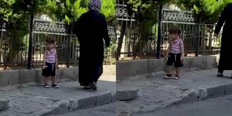 Çocuğu belinden iple bağlayıp gezdiren kadın tepki çekti