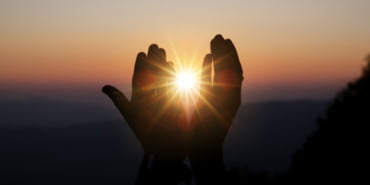 spiritual-prayer-hands-sun-shine-with-blurred-beautiful-sunset_1150-7173